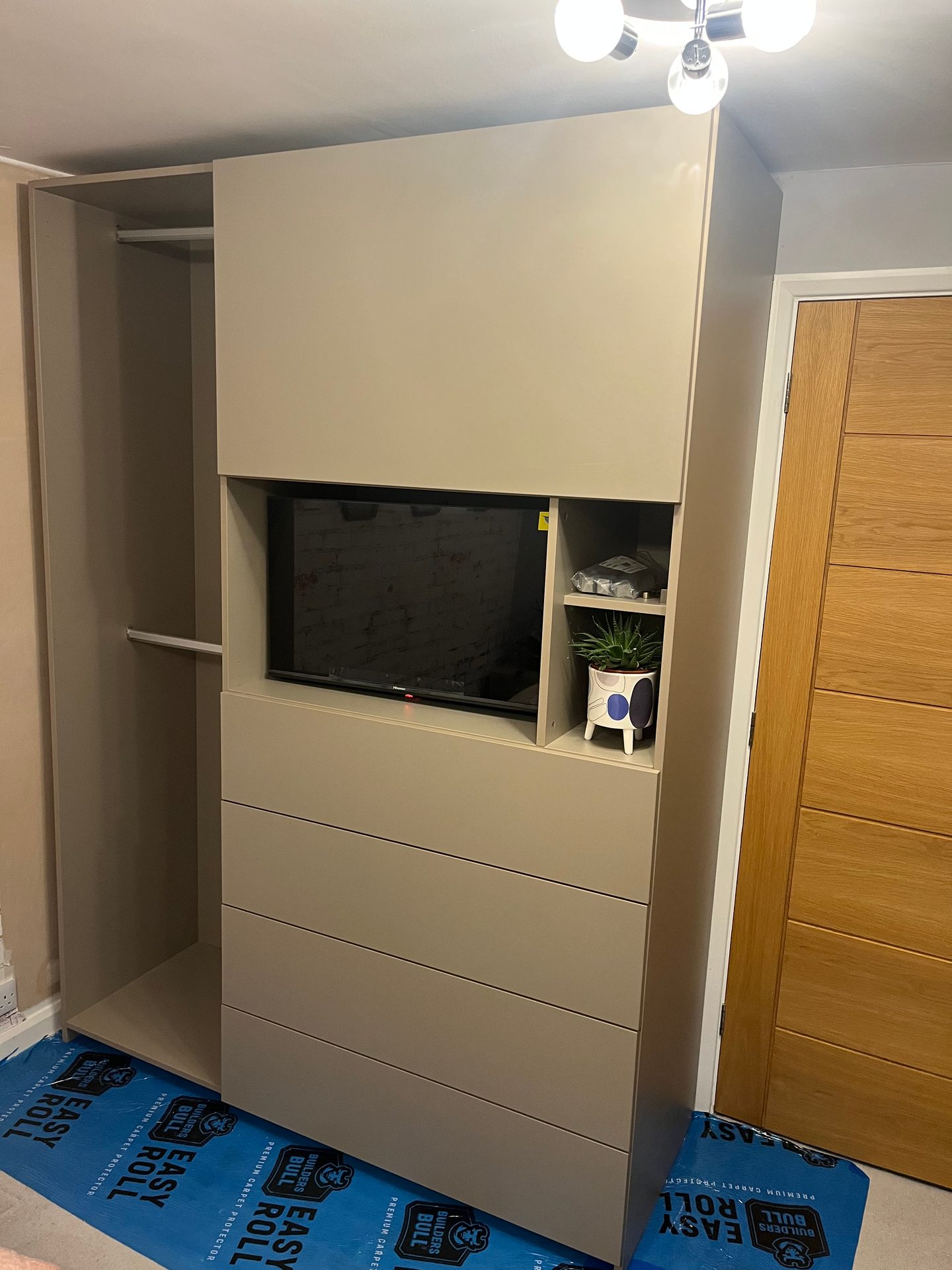 Tall TV wall unit with an open shelf and drawers