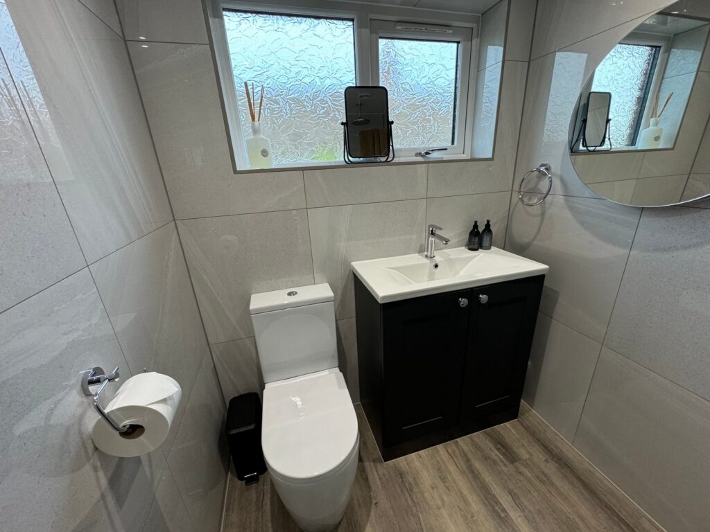 Small cloakroom with a black shaker vanity unit