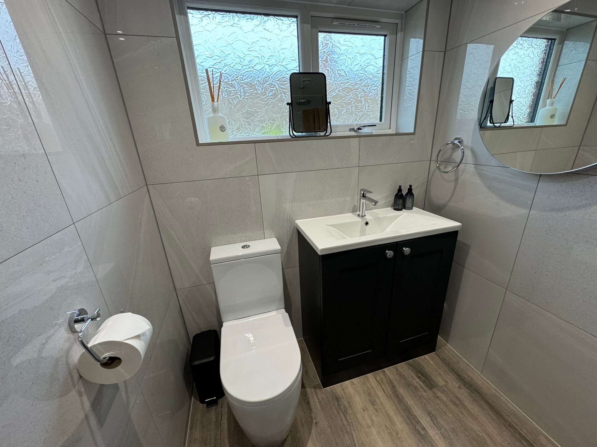 Small cloakroom with a black shaker vanity unit