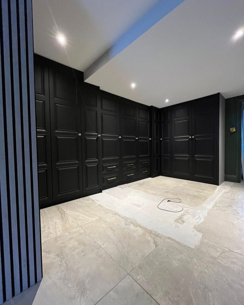 L-shaped run of black shaker fitted wardrobes