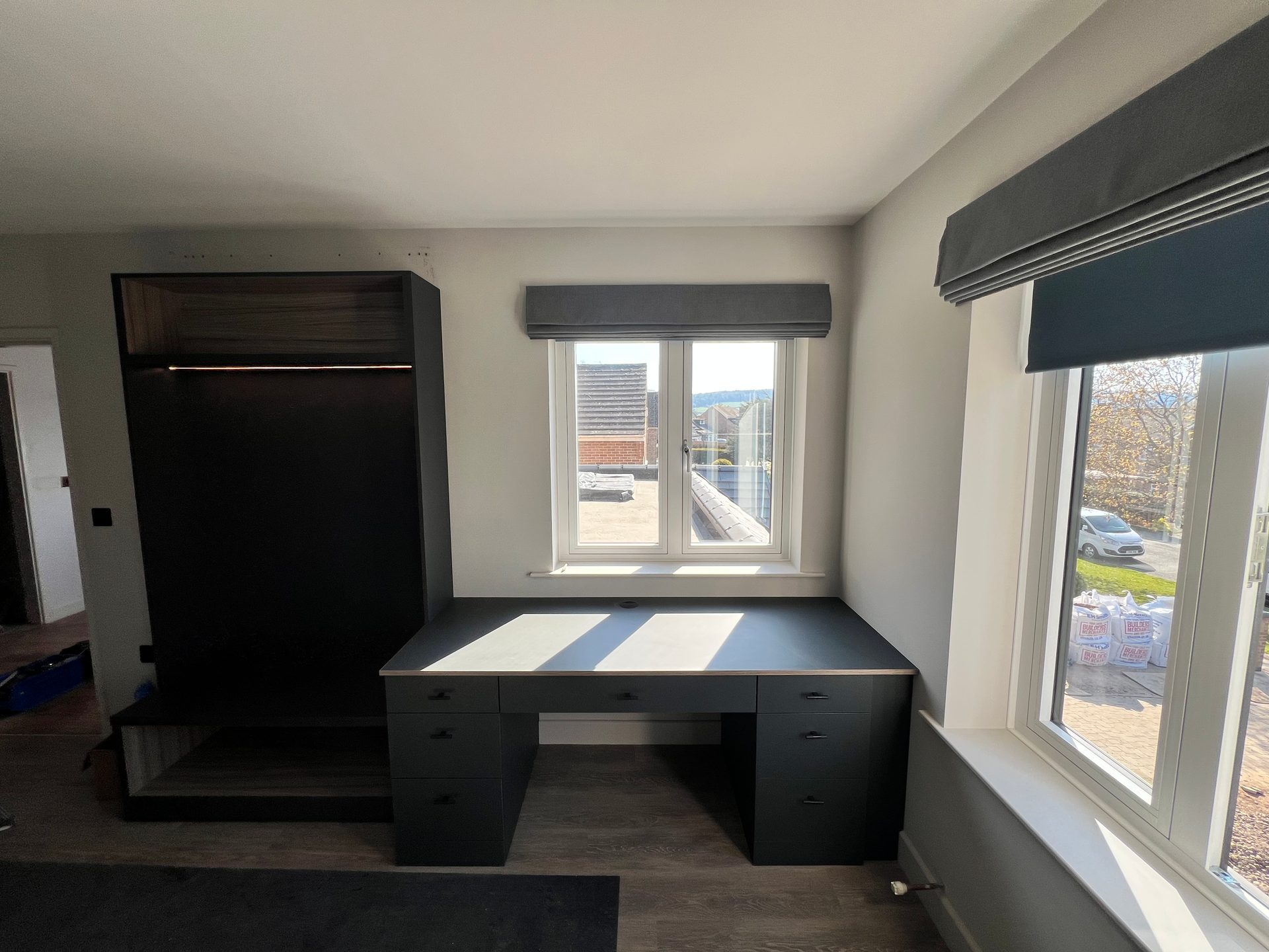 Built-in desk with drawers under a bedroom window