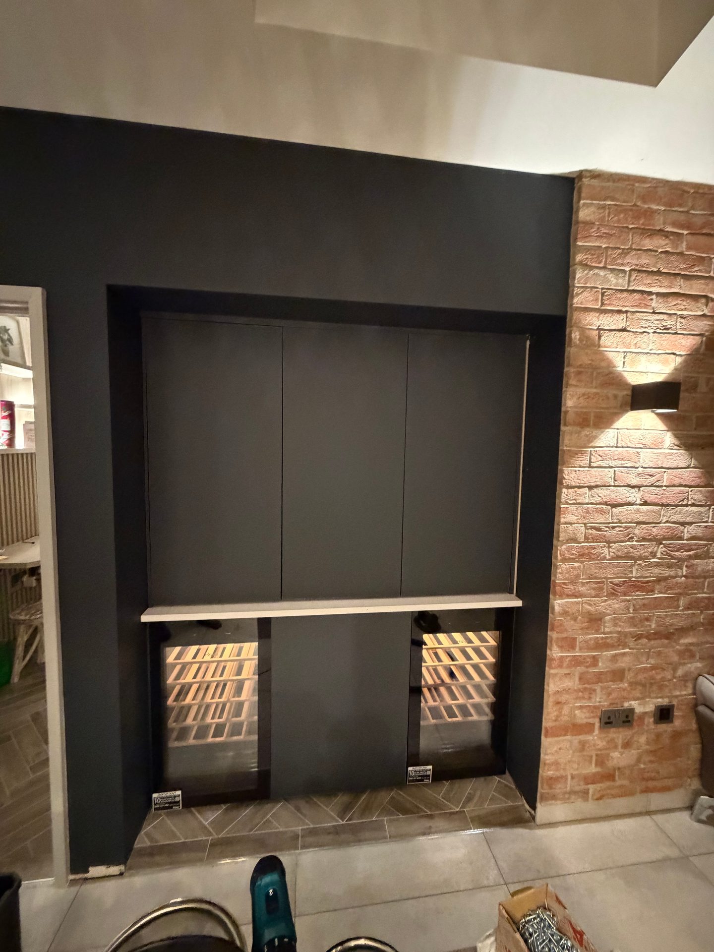 Home bar with its flush doors closed over the shelving
