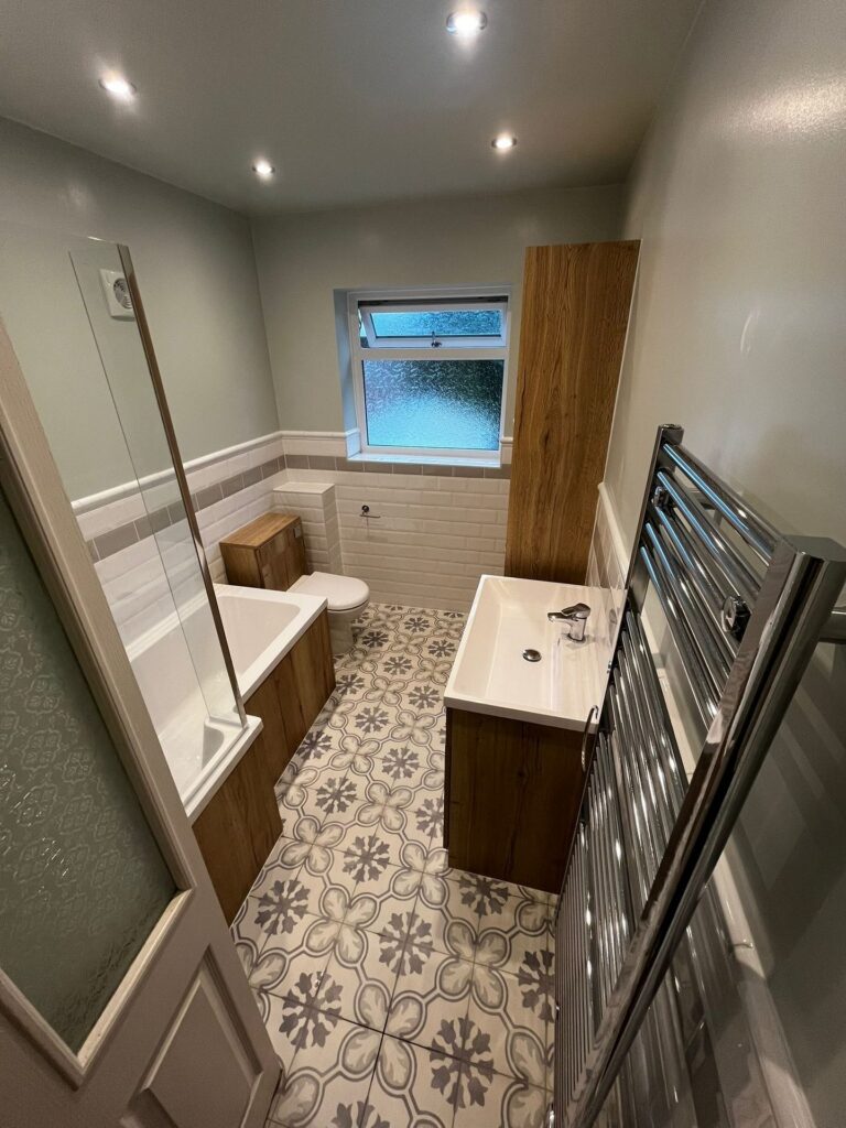 Bathroom with oak-effect vanity unit, tall cupboard and bath panel