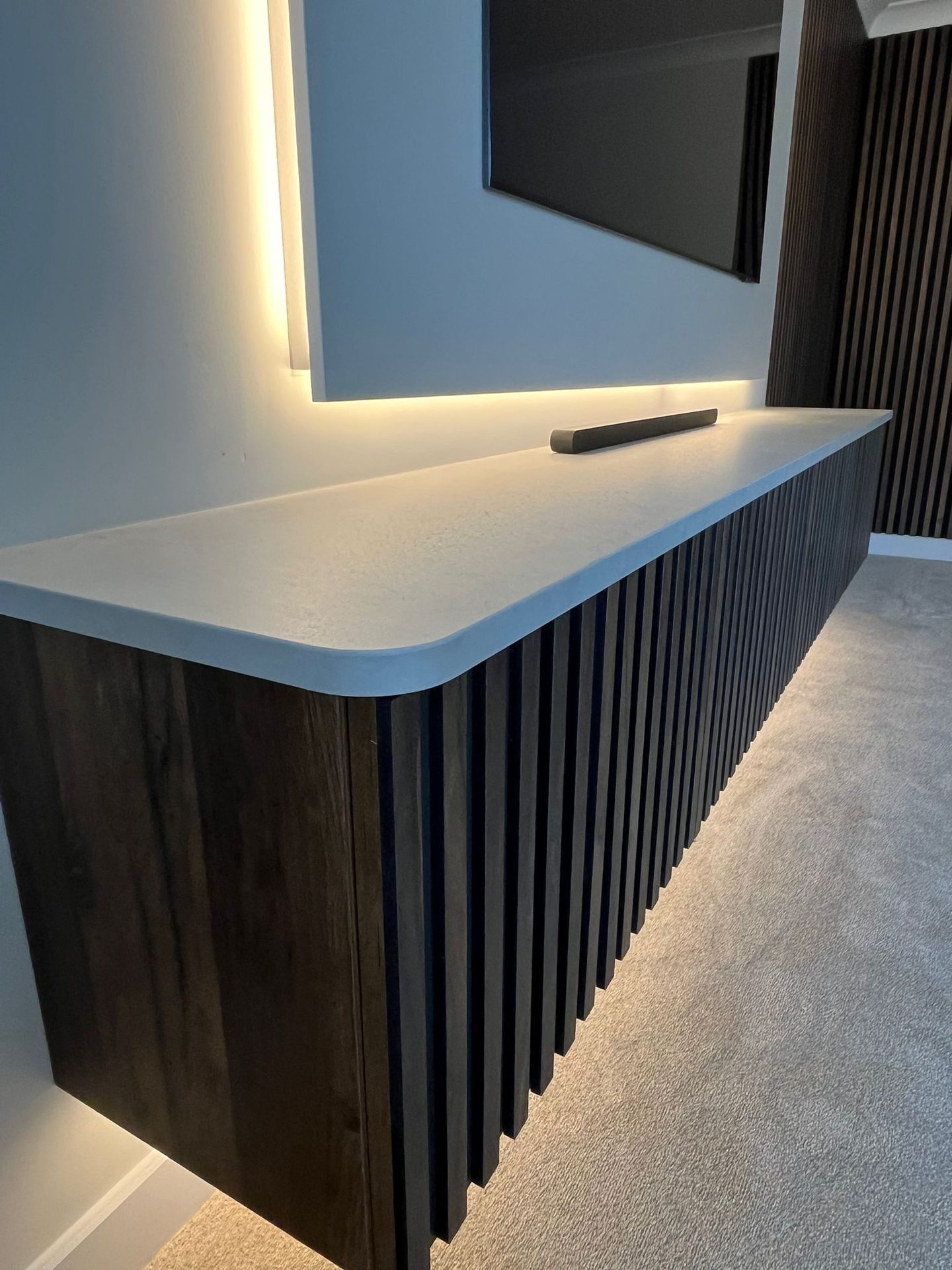 Curved end of a slatted base unit with LED lighting underneath