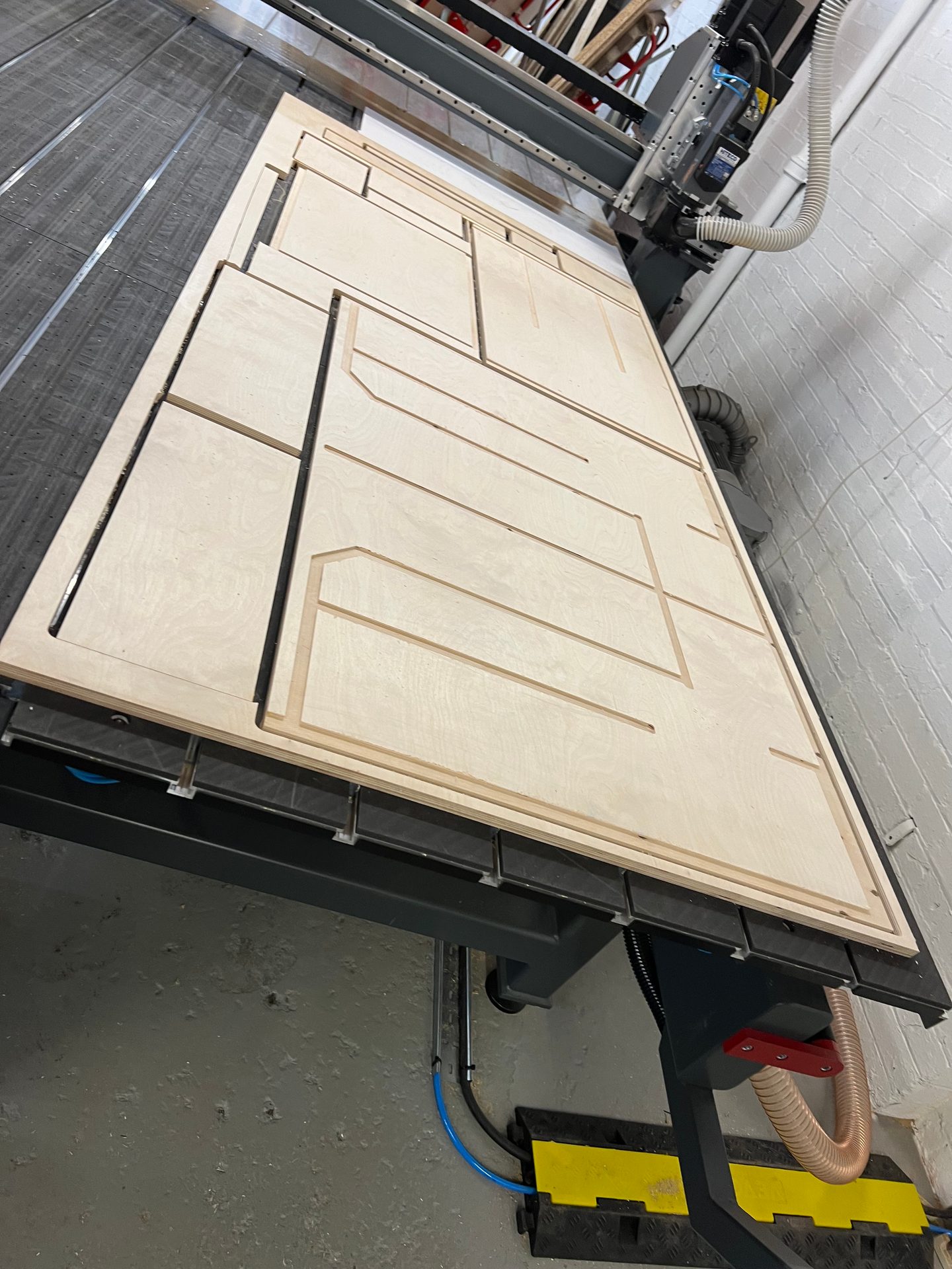 Speaker cabinet parts nested on a sheet on the CNC