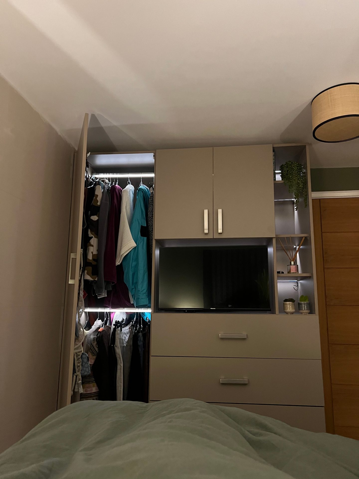 Bedroom wardrobes with a TV recess, lit hanging and drawers