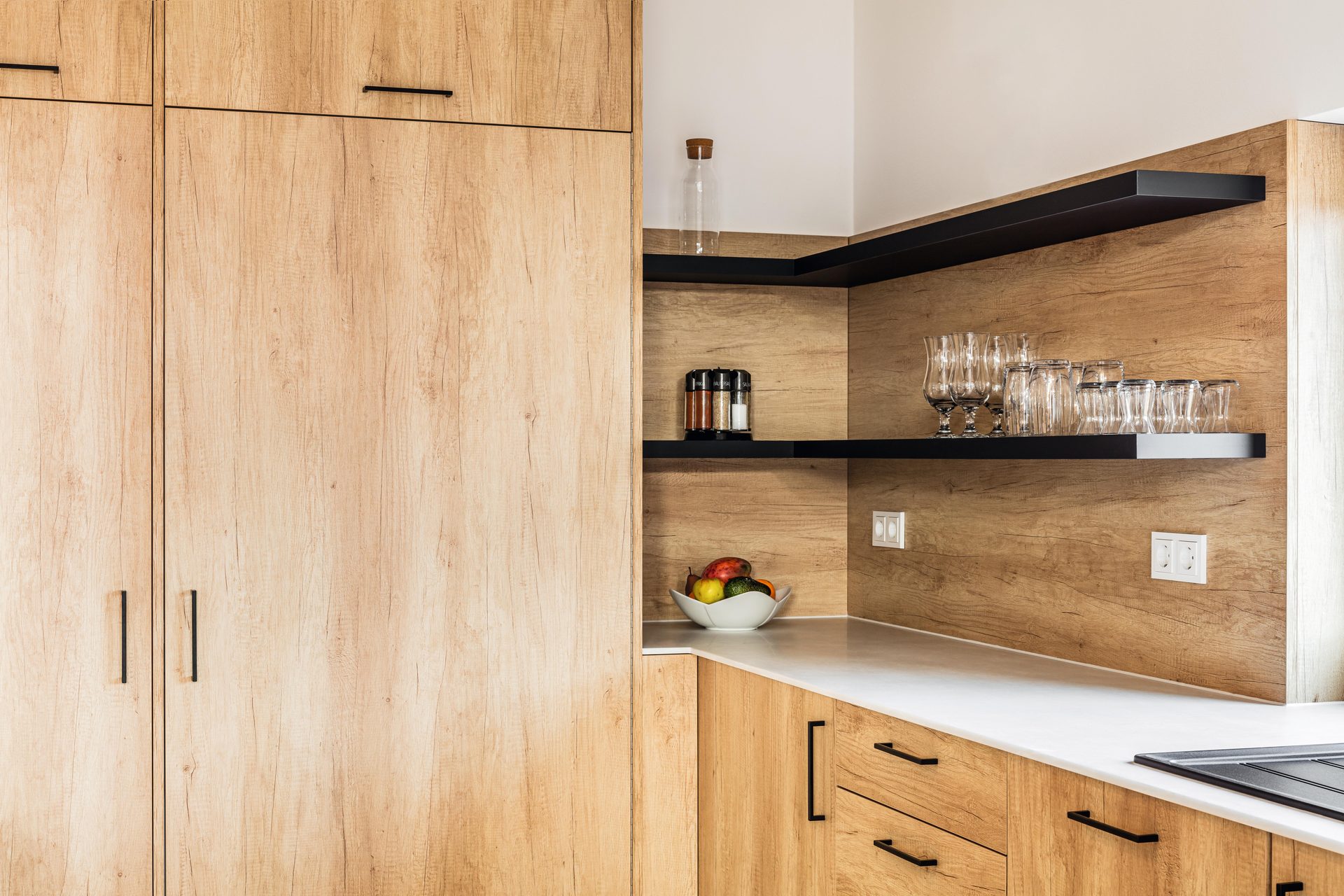 Natural Nebraska Oak tall units and splashback with black open shelves