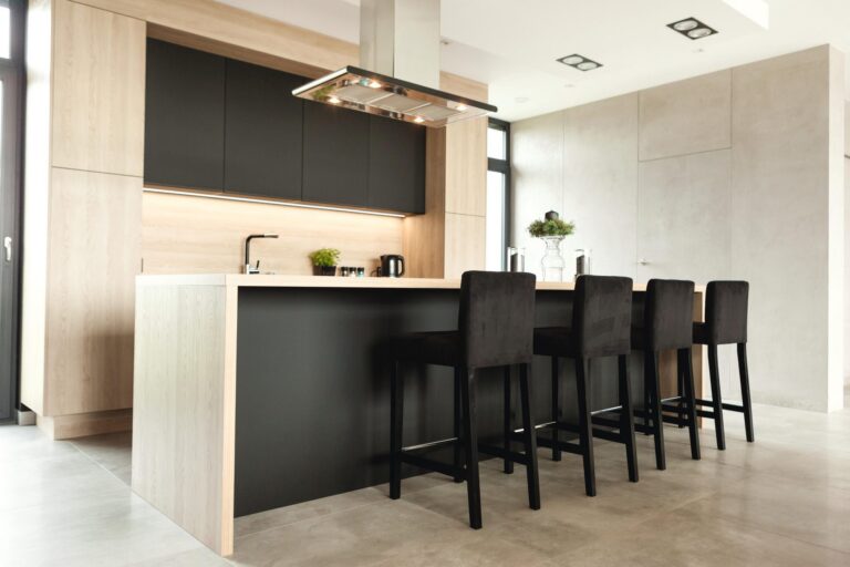 An oak and black kitchen island in an open-plan room