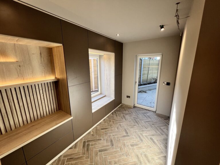 Slatted office wall with lit niche